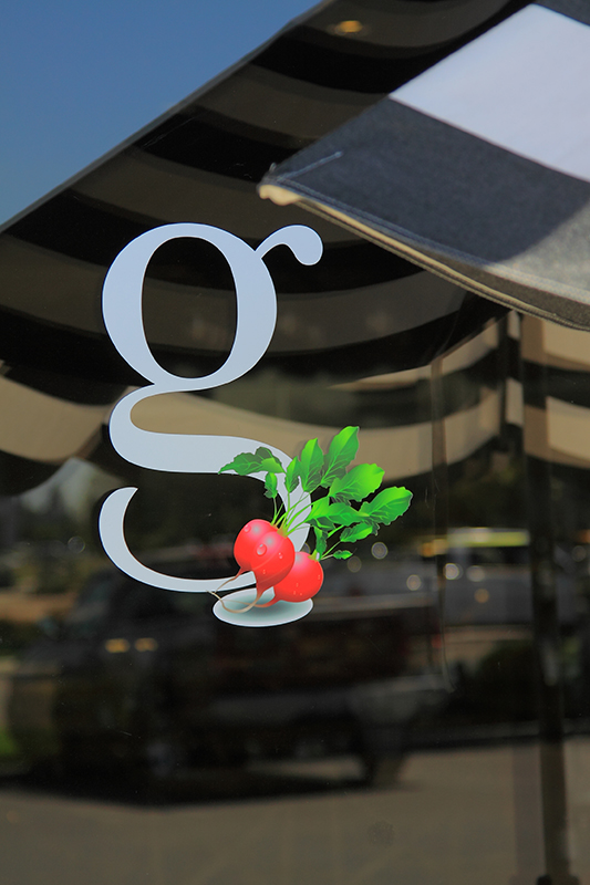 Greens logo on a reflective glass